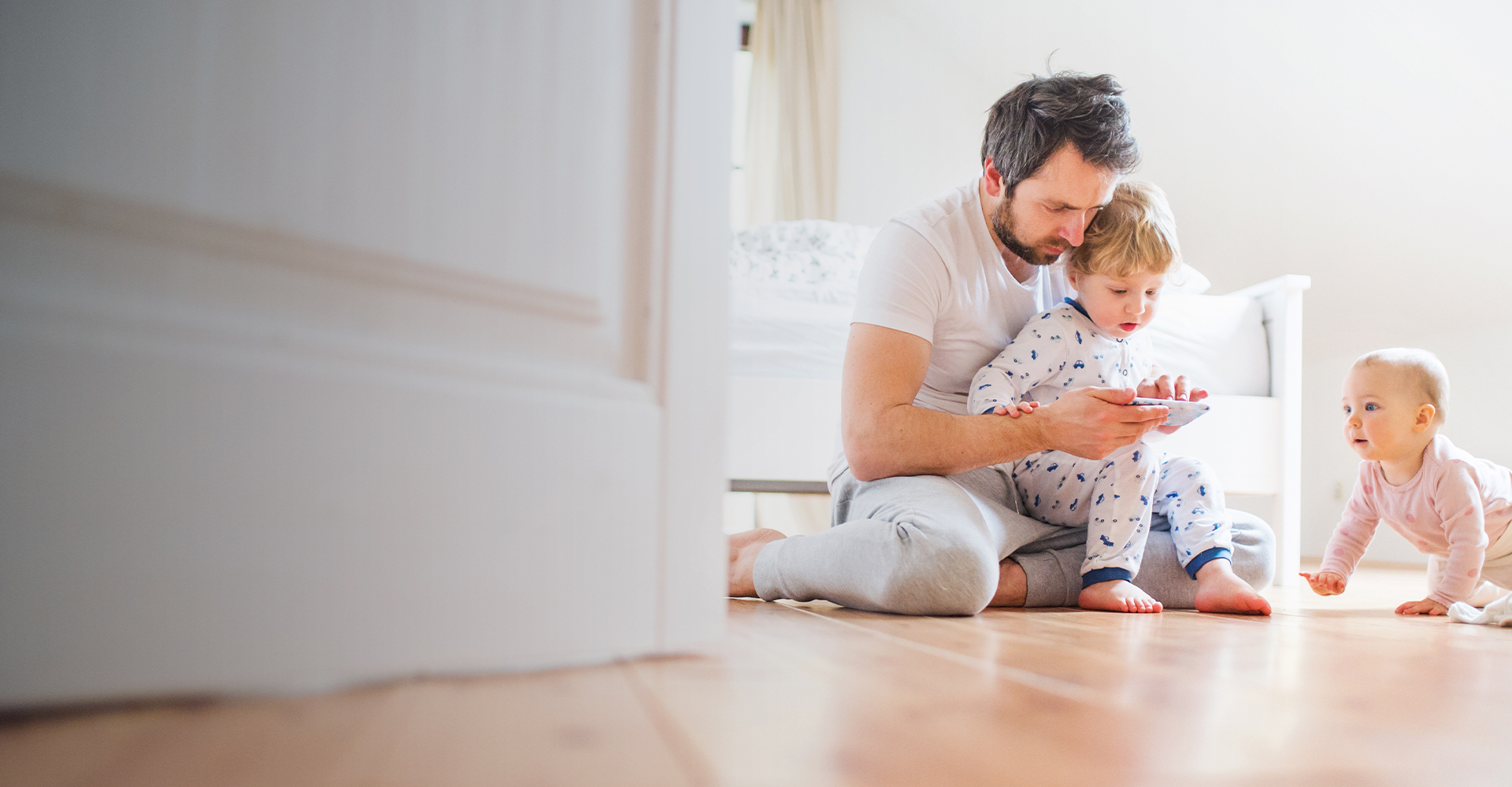 Family playing games in a living room with a hardwood floor