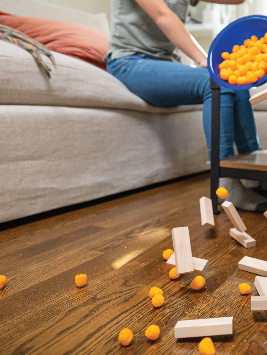 Family playing games in a living room with a hardwood floor